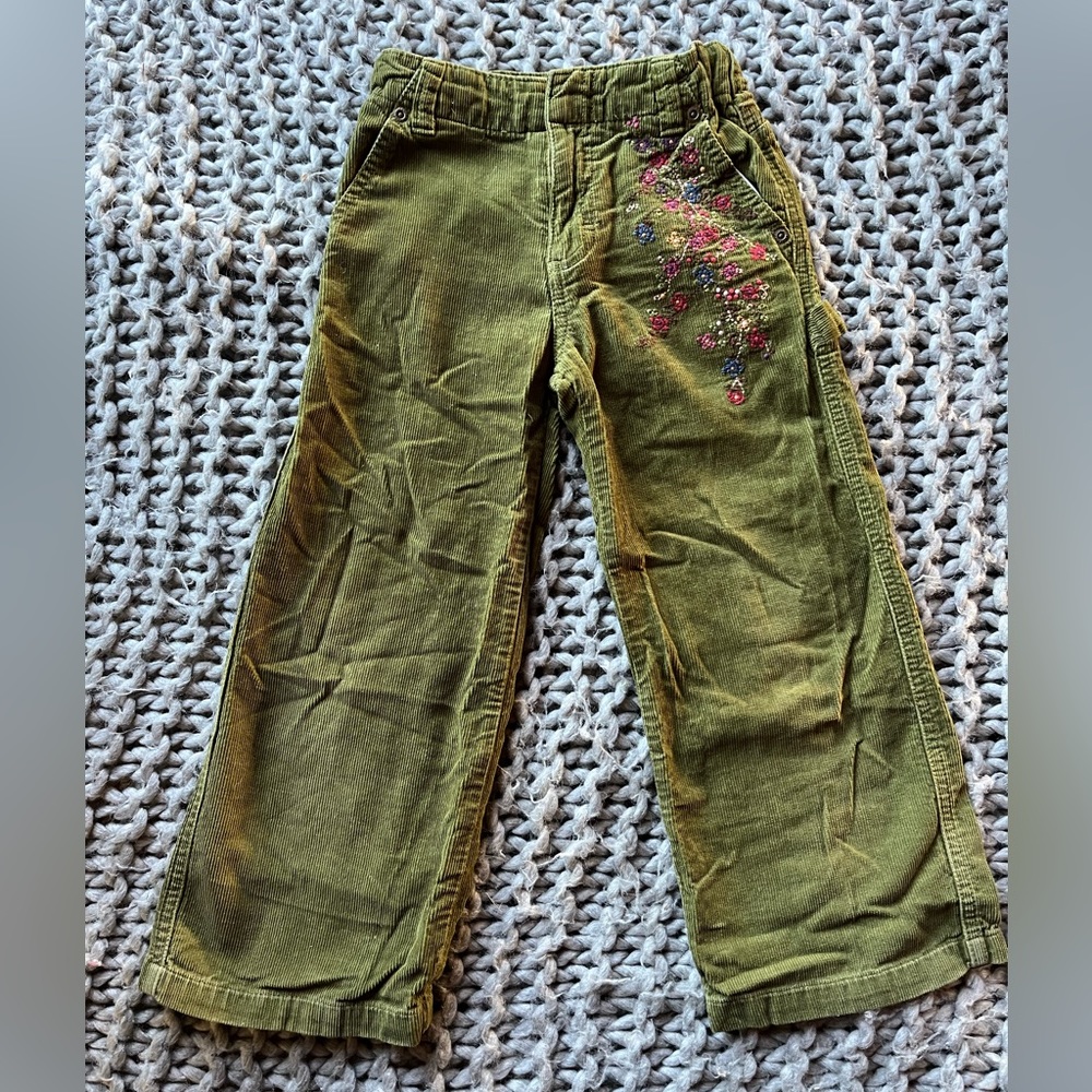 green denim jeans with beautiful embroidered flowers on back a front pockets